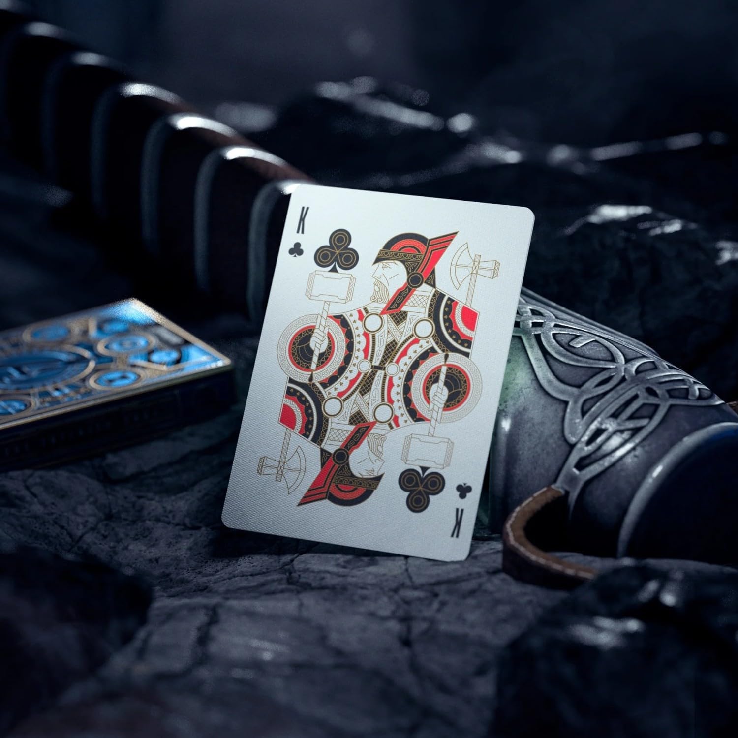 Playing card with a detailed design on a dark textured surface