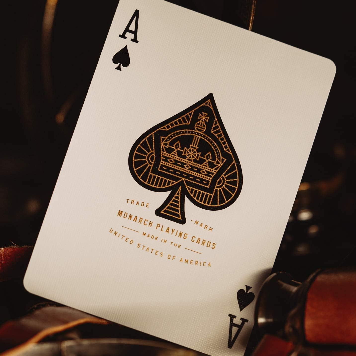 Ace of Spades playing card with Monarch Playing Cards branding on a dark background