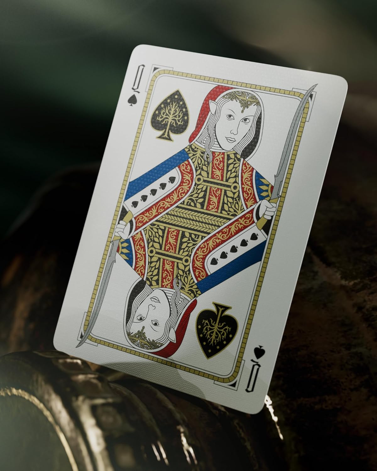 Playing card featuring a queen of spades design on a textured surface.