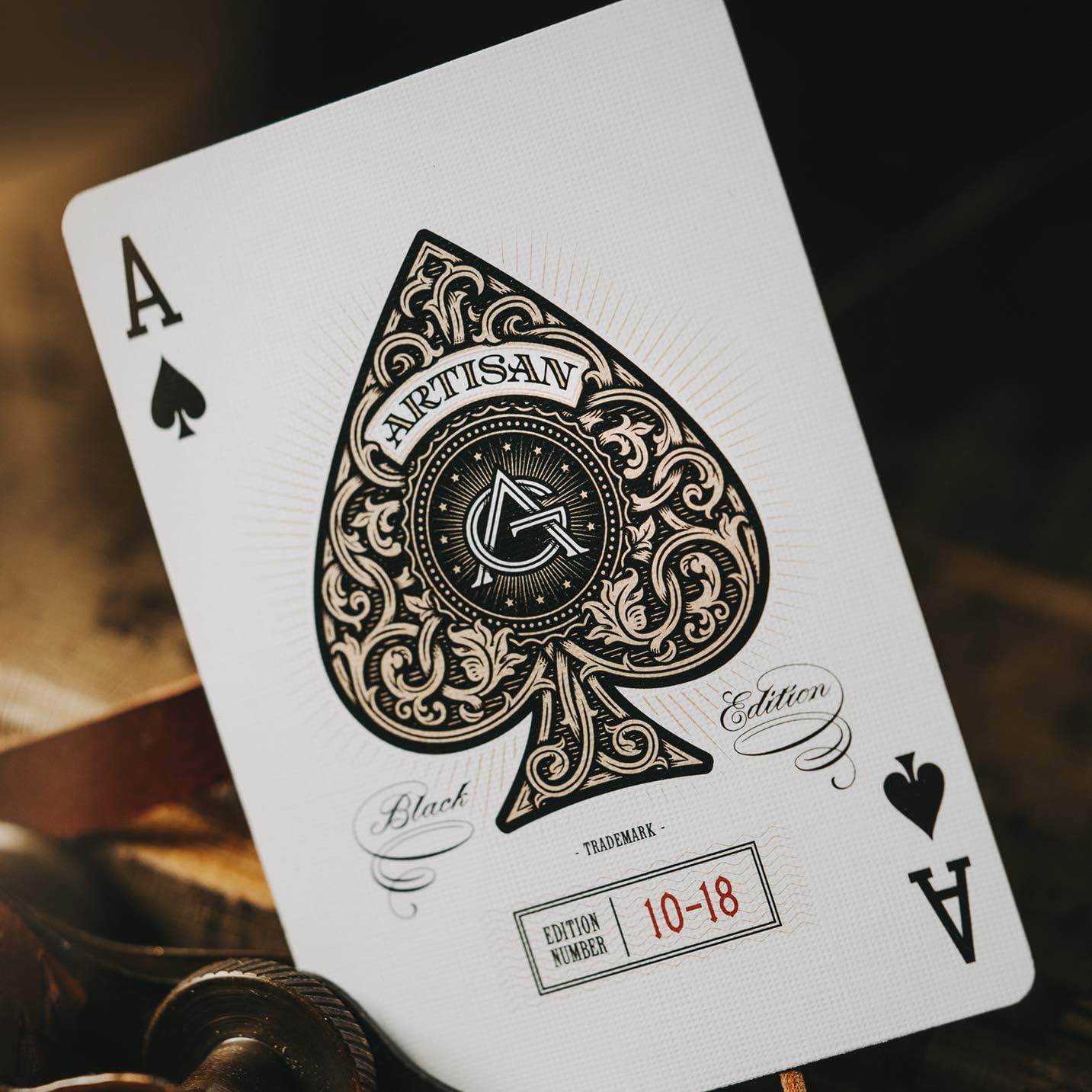 Playing card with intricate design and 'Artisan Edition' text on a dark background