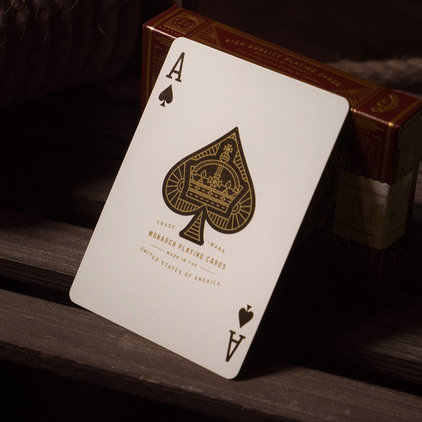 Ace of Spades playing card with a red Monarch box in the background