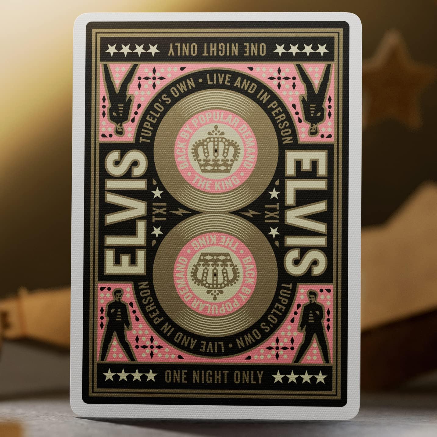 Card back from Theory11 Elvis deck featuring mirrored records, crowns, and Elvis silhouettes in pink and gold.