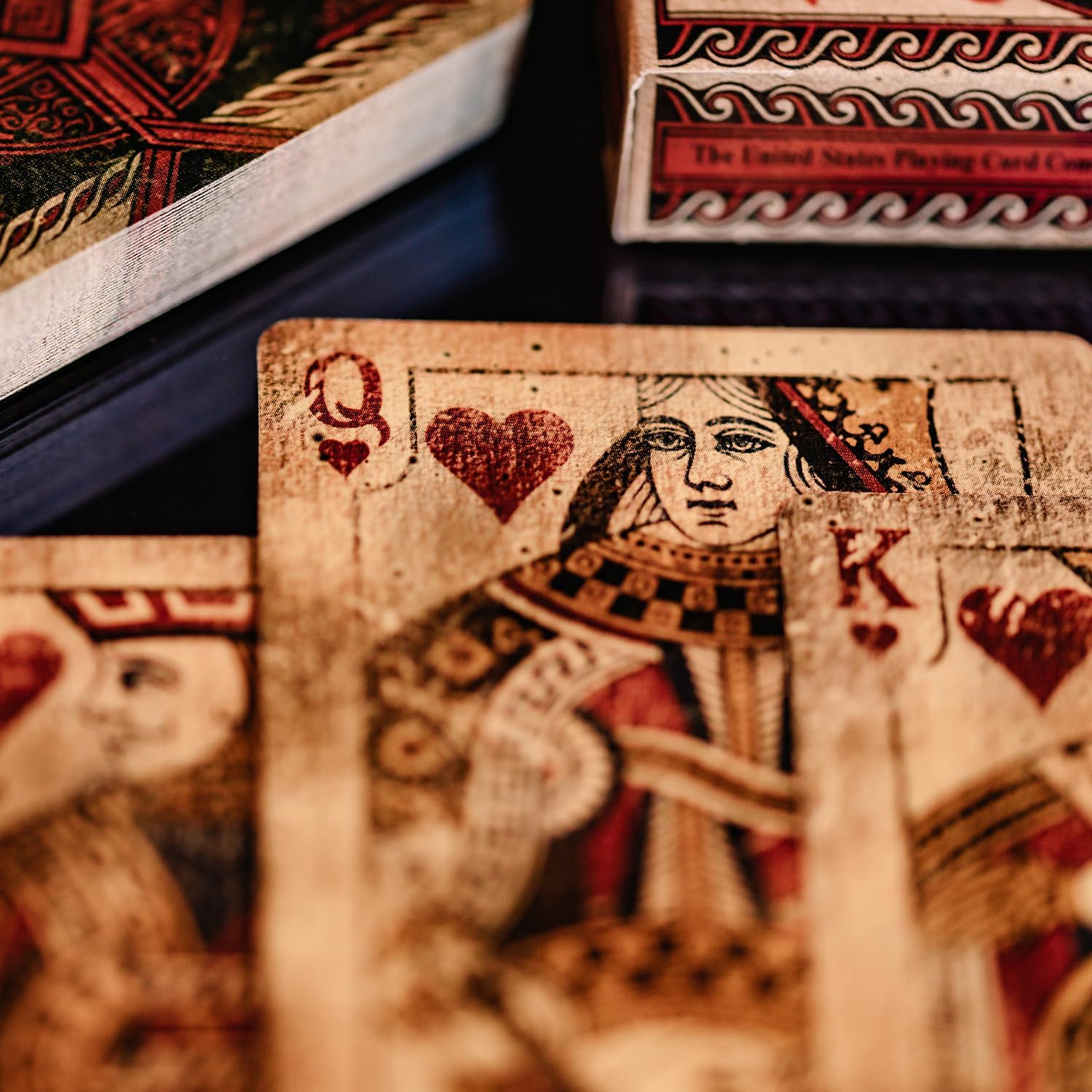 Close-up of playing cards with a Queen of Hearts card in focus.