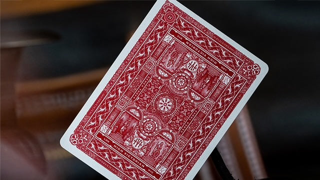 Red playing card with intricate design on a blurred background