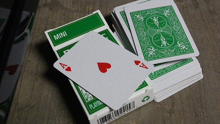 Bicycle Mini Playing Cards with green and white design on a wooden surface