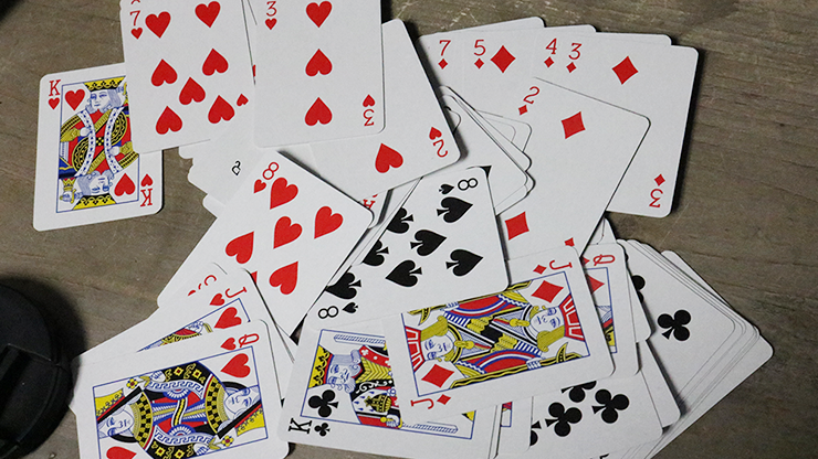 Scattered Bicycle Mini Playing Cards on a wooden surface