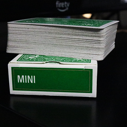 Stack of Bicycle Mini Playing Cards in Green with a box labeled 'MINI' on a dark surface.