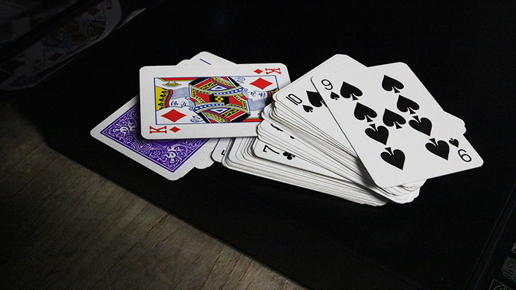 Bicycle Mini Playing Cards in Purple scattered on a dark surface