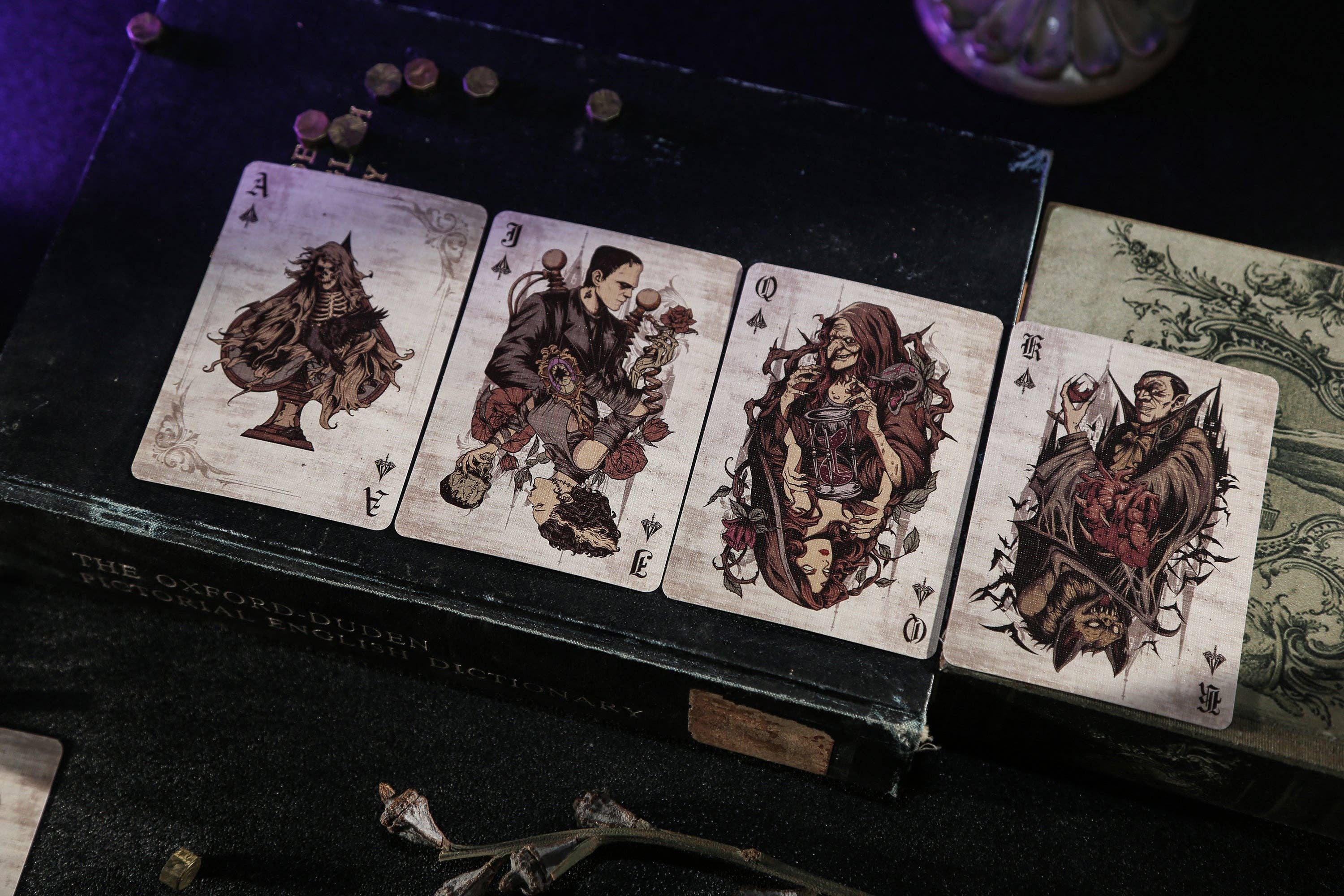 Set of tarot cards with intricate designs on a dark surface