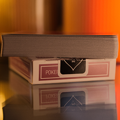 Bicycle Metallic Ruby Playing Cards in a box with a blurred colorful background