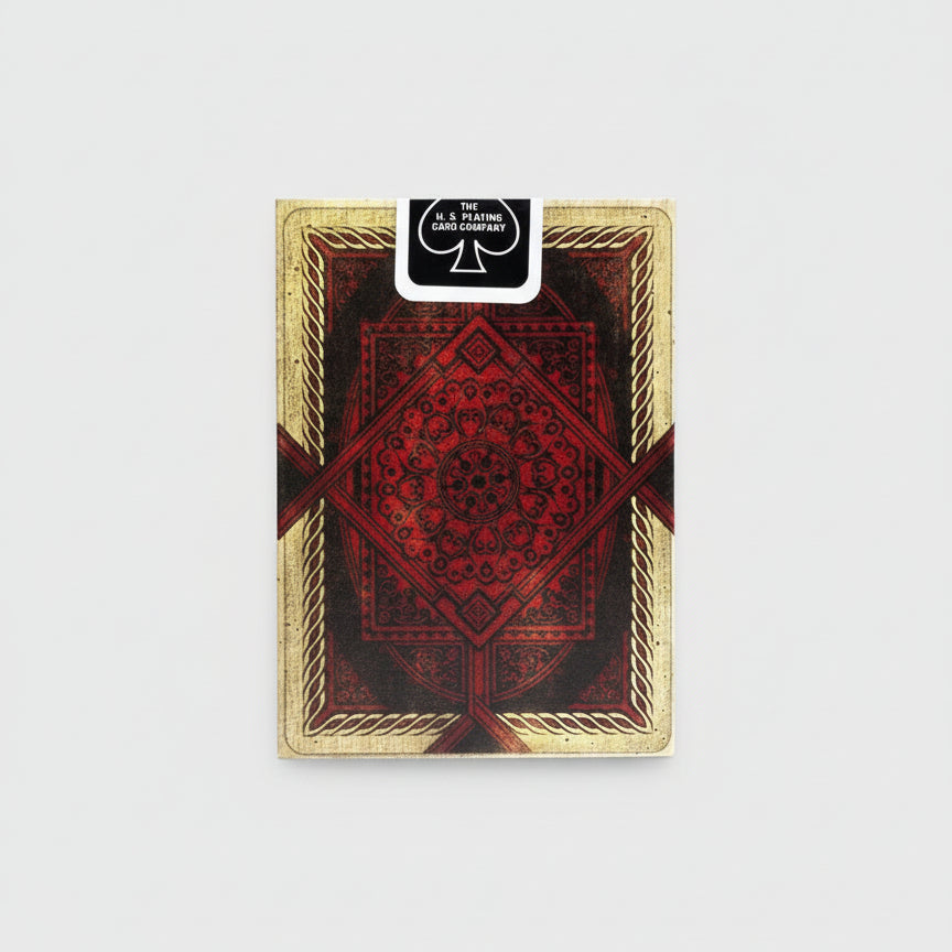 Playing card with red and gold design, featuring U.S. Playing Card Company logo.