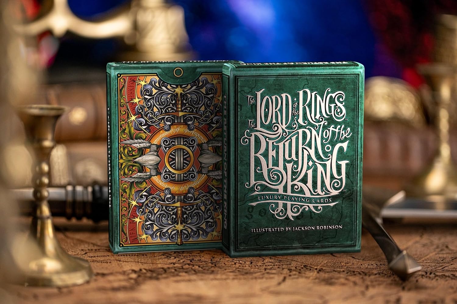 Two packs of 'The Lord of the Rings' playing cards on a wooden surface with a blurred background.