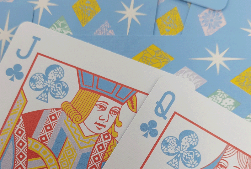 Colorful playing cards with decorative designs on a blue background