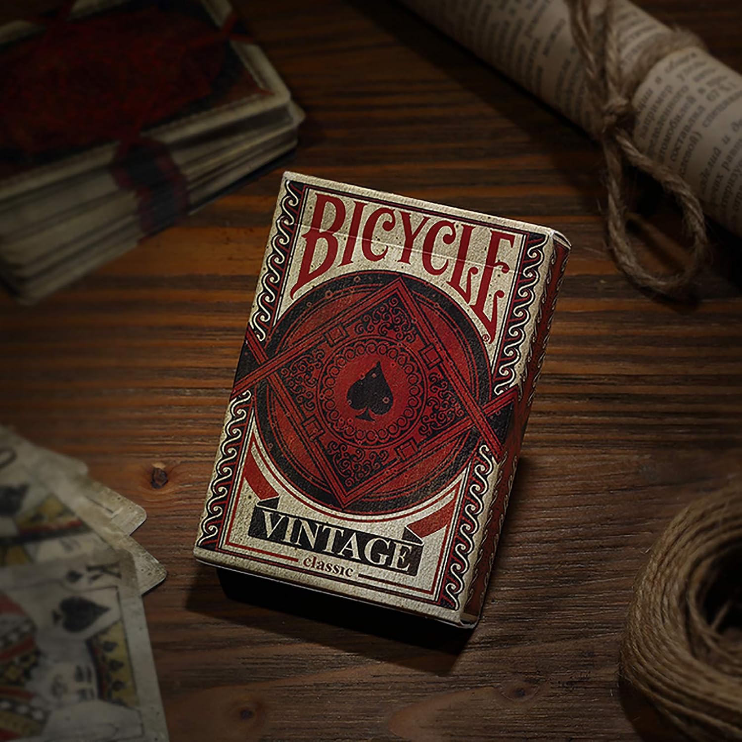 Bicycle Vintage playing cards on a wooden surface with cards and string in the background