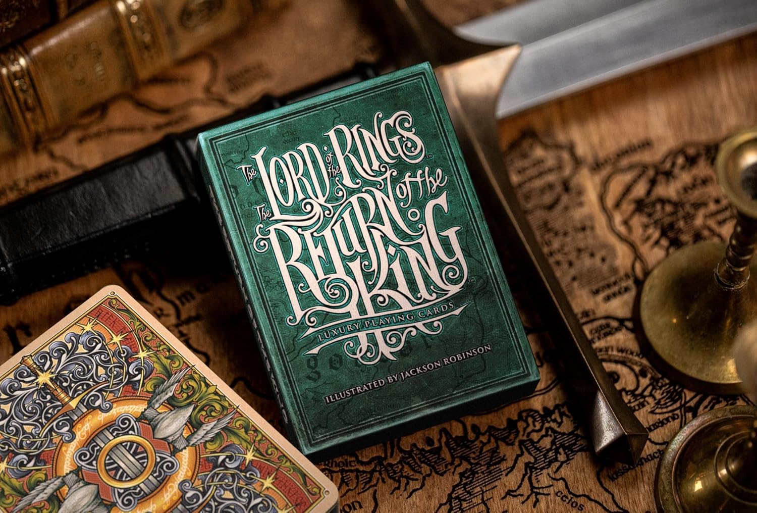 Opened Return of the King tuck showing full card back artwork next to closed box on map background.