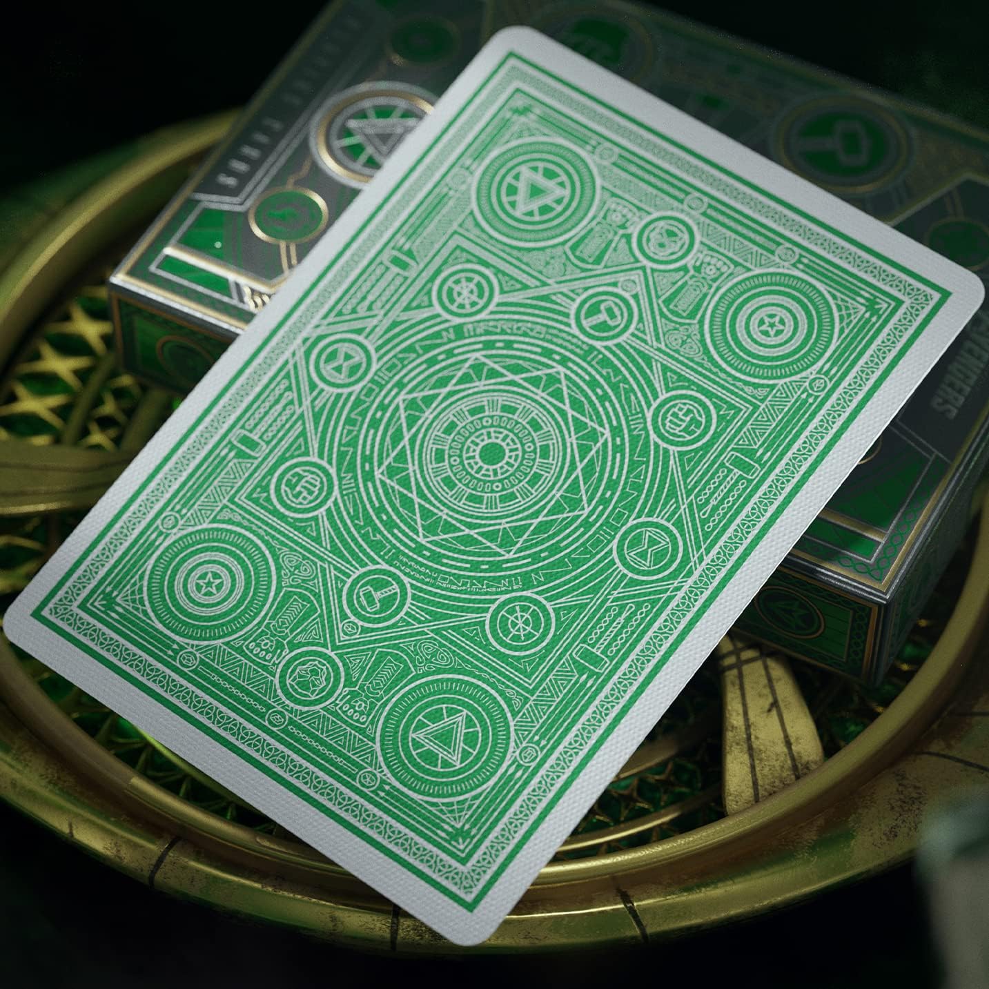 Green playing card with intricate design on a circular object