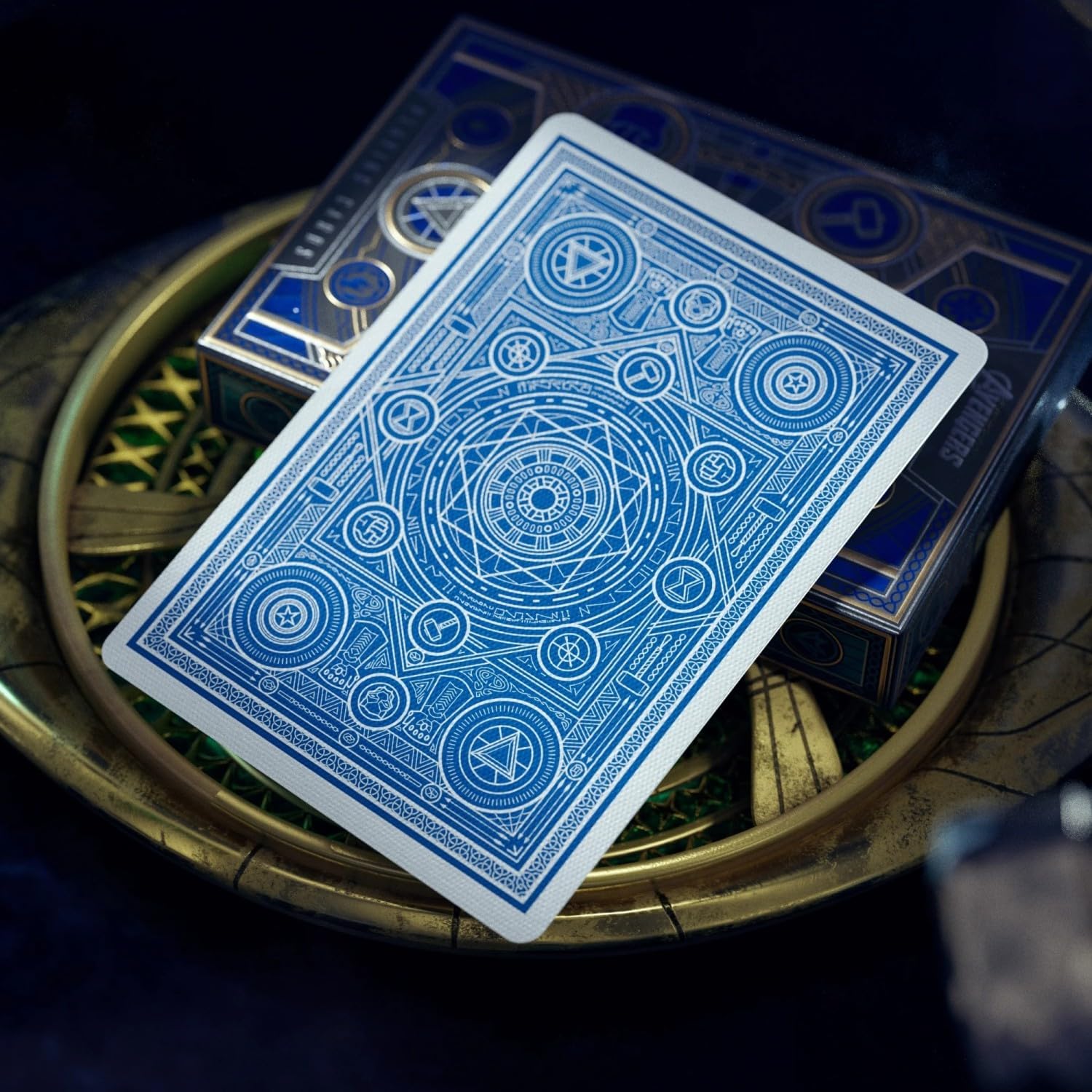 Blue playing cards with intricate designs on a dark background
