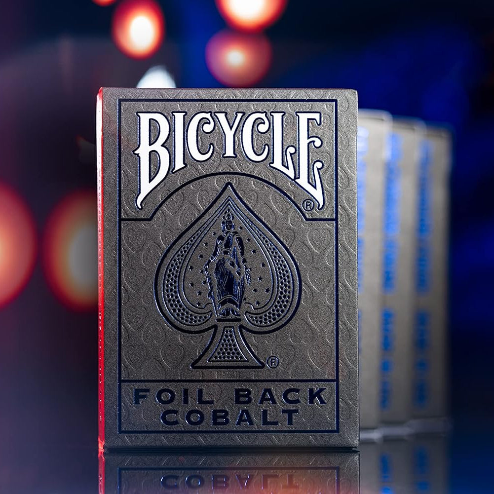 Bicycle Foil Back Cobalt playing cards with a blurred colorful background