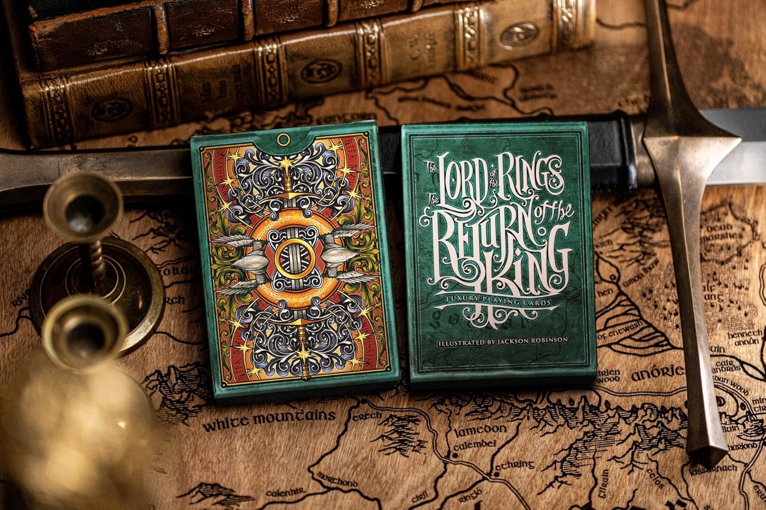Angled view of Return of the King tuck resting on vintage map with sword and props.”