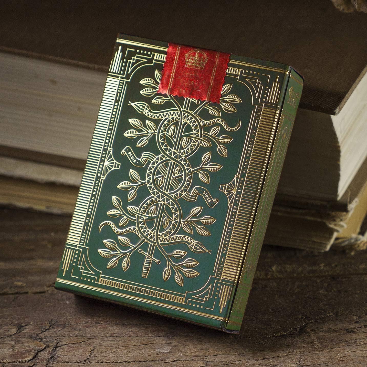 Decorative green Monarch box with gold embossing on a wooden surface