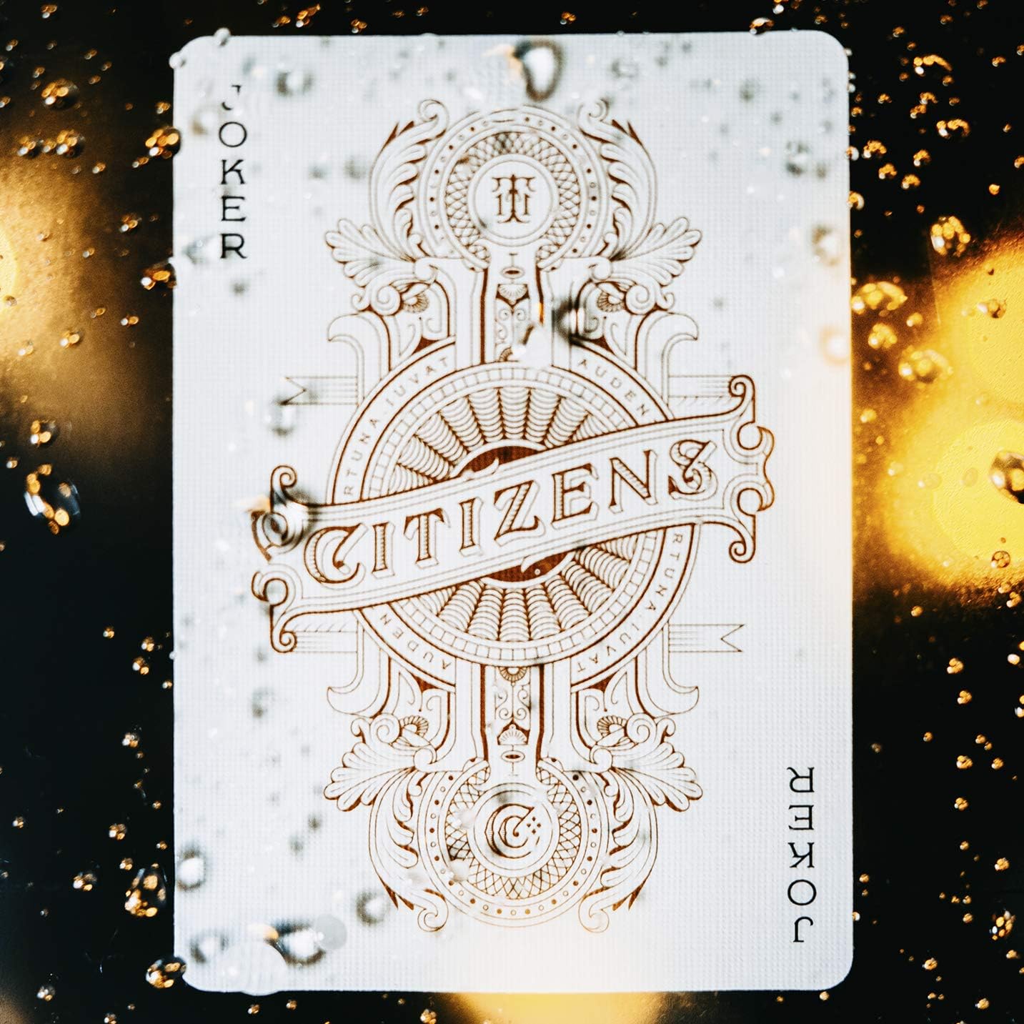 Playing card with ornate design and 'Citizens' text on a blurred golden background