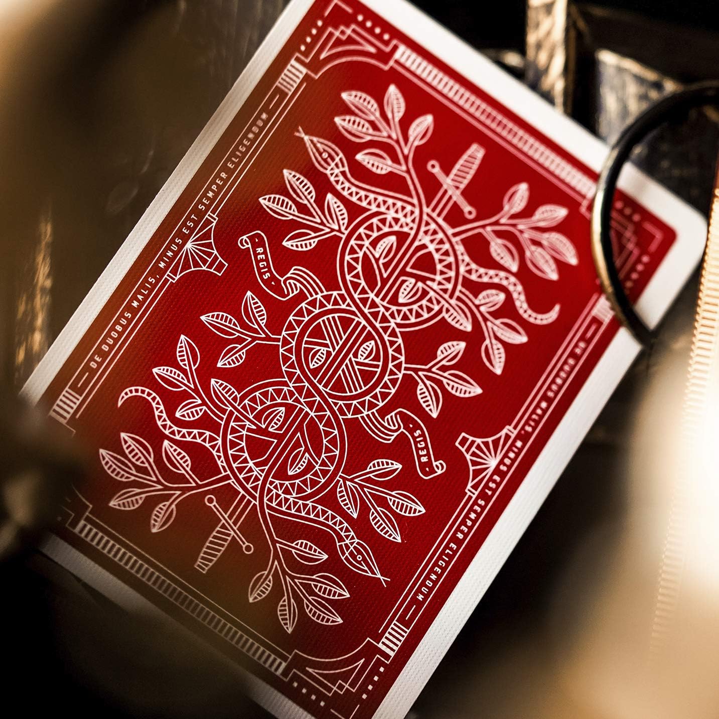 Close-up of a red Monarch playing card with white intricate design