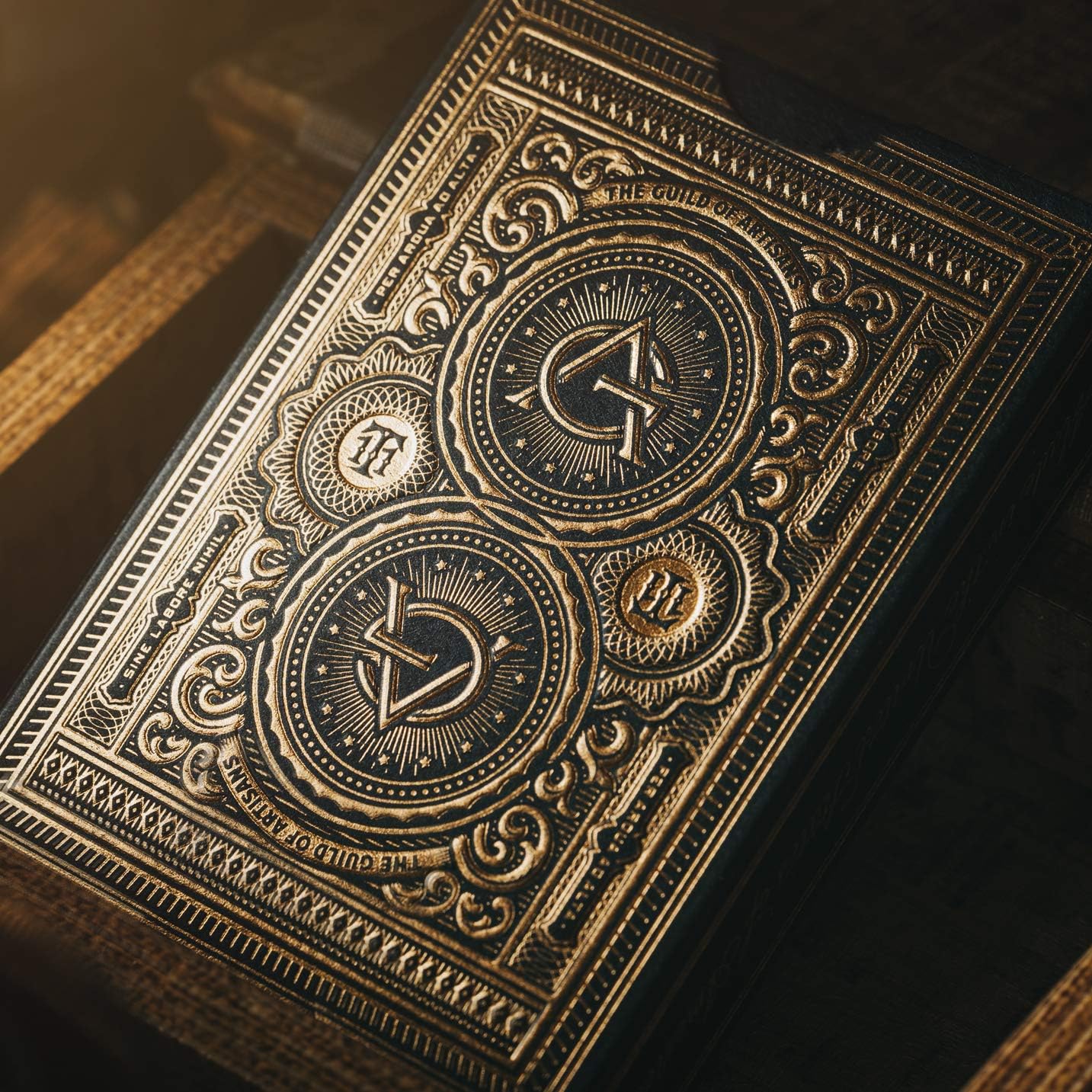 Decorative gold-bound book with intricate designs on a dark background