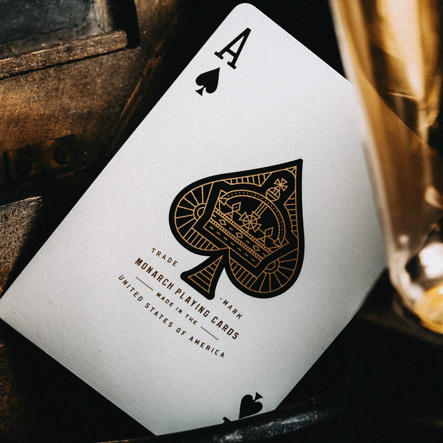Ace of spades playing card with Monarch Playing Cards branding on a dark background