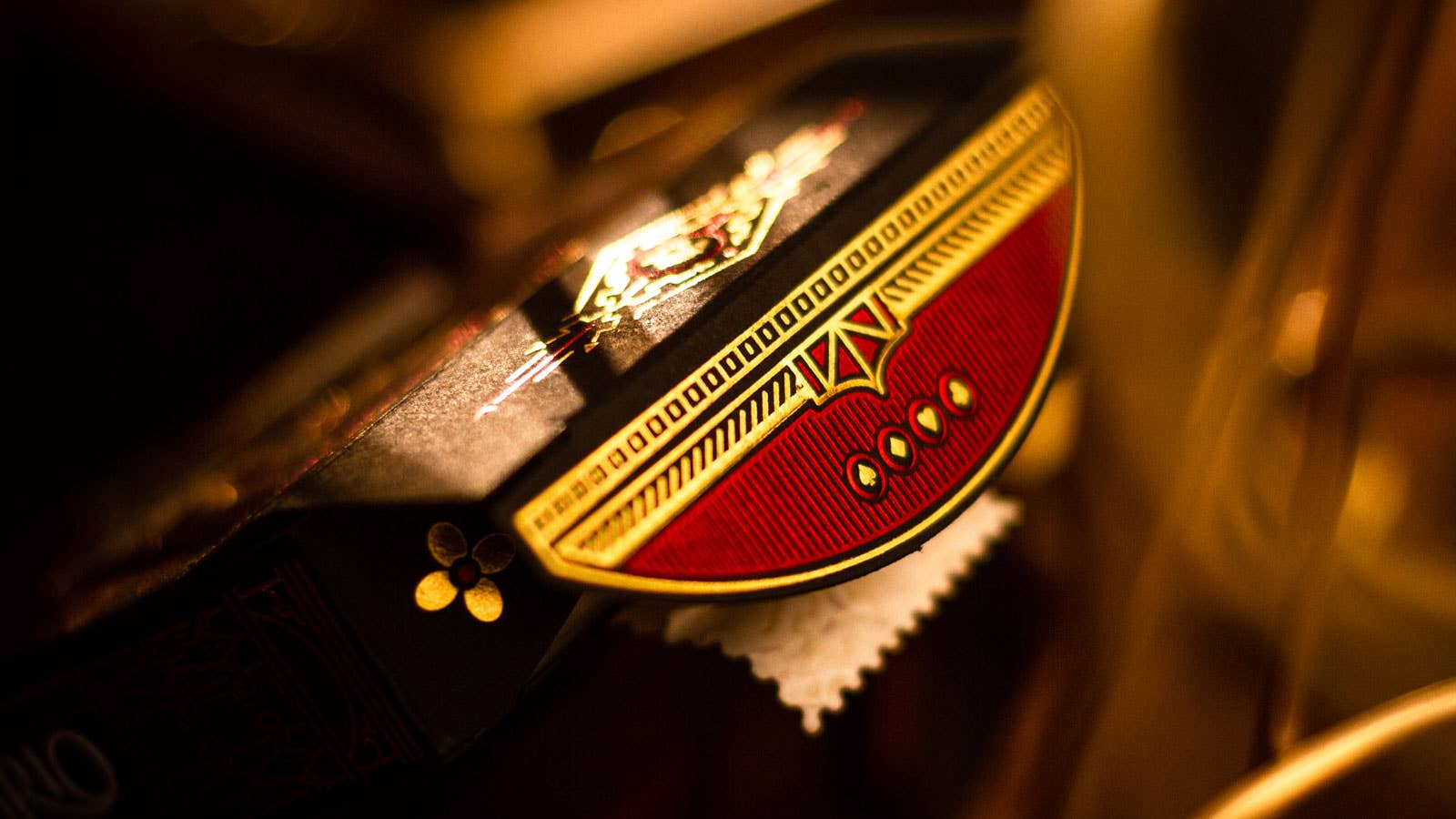 Close-up of an emblem with a red and gold design on a blurred background