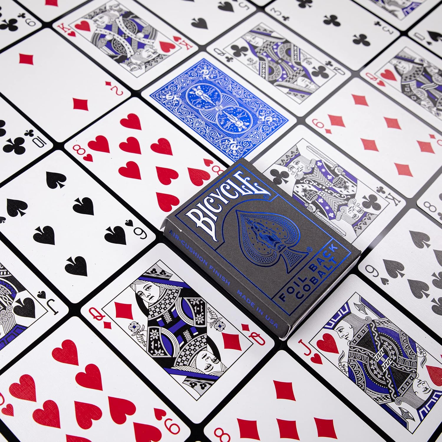 Bicycle Metalluxe Cobalt deck on a spread of standard faces showing blue foil Rider Back card and recolored courts.