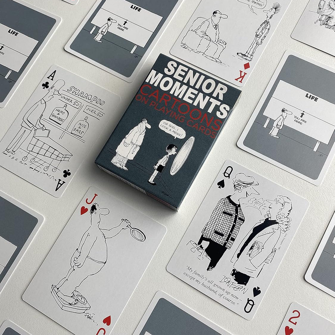 Piatnik Senior Moments deck showing black-and-white cartoons and custom gray card backs