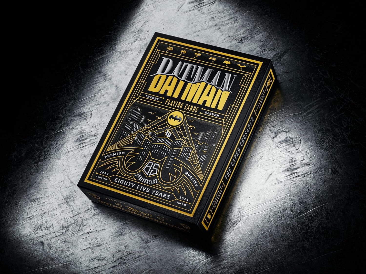 Batman-themed playing card box on a dark textured surface