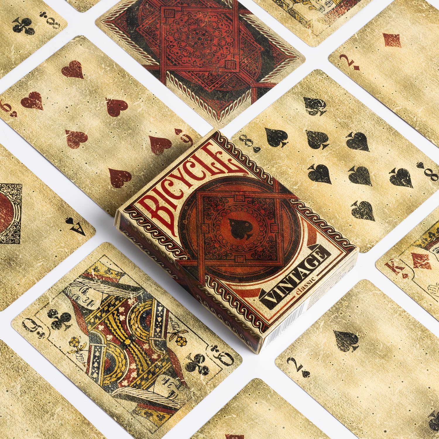 Bicycle vintage playing cards with a deck of cards displayed around it.