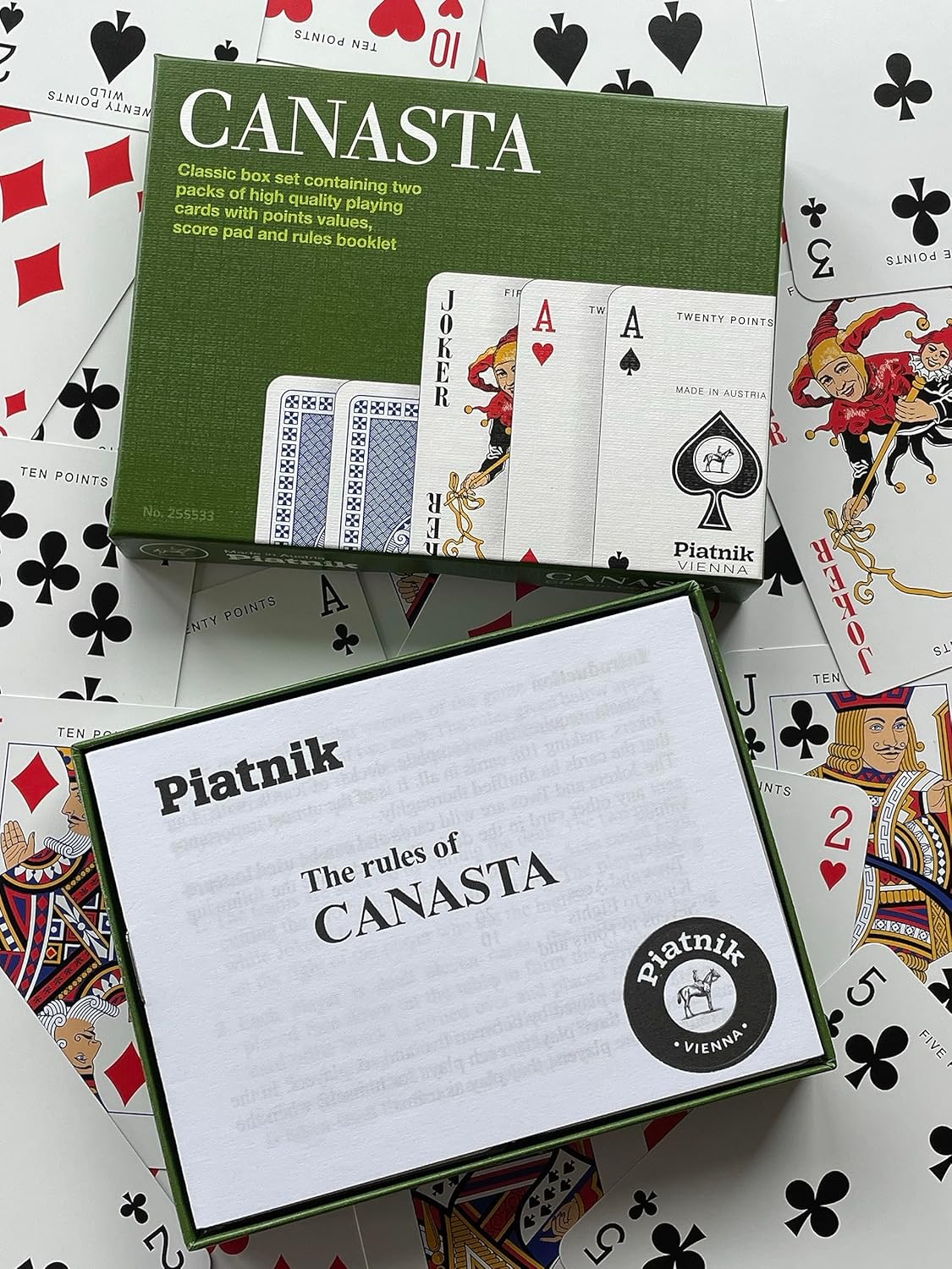Canasta playing card set with rules sheet on a playing card background