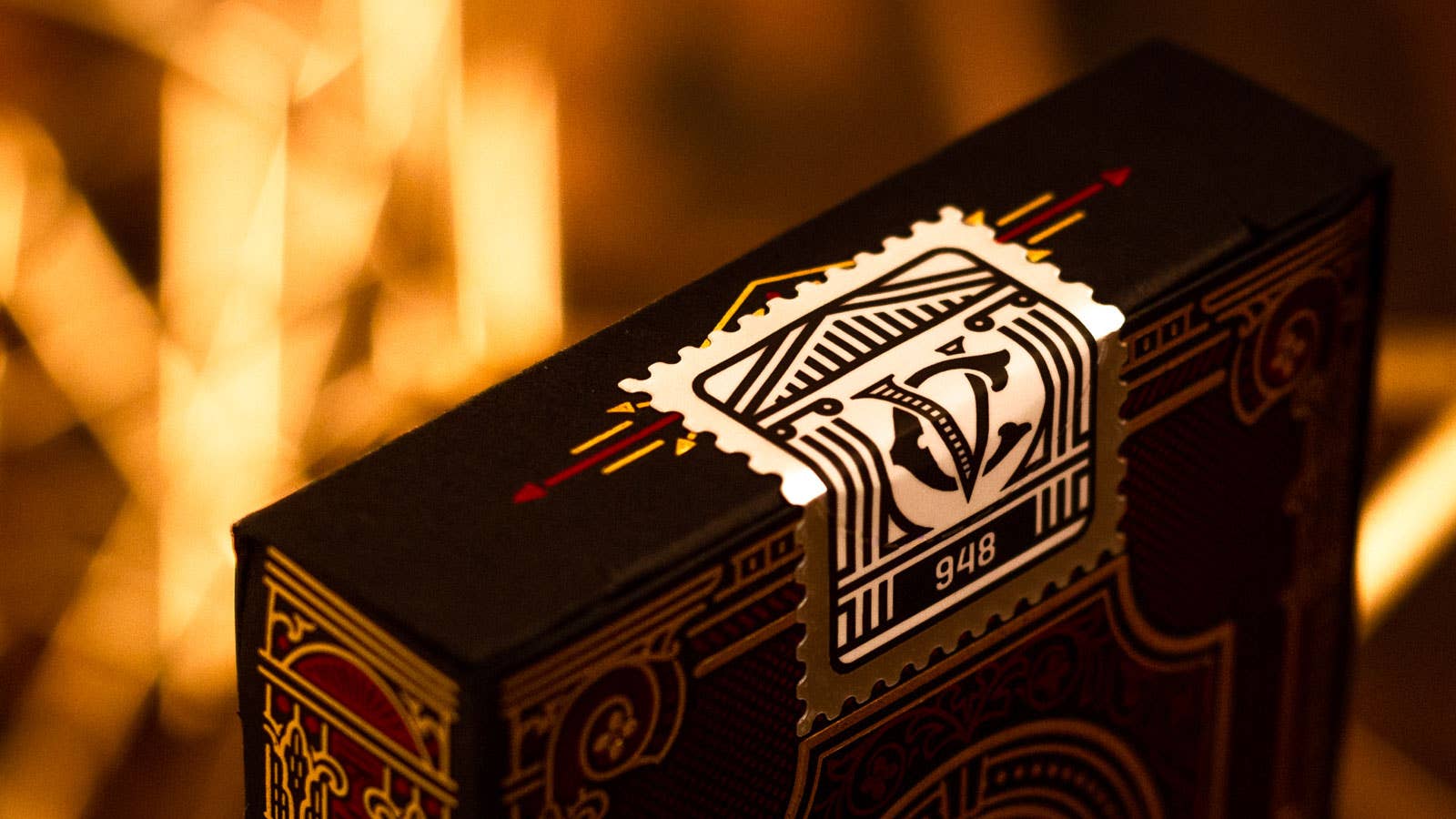 Decorative Centurio box with intricate design and visible brand logo against a warm, blurred background