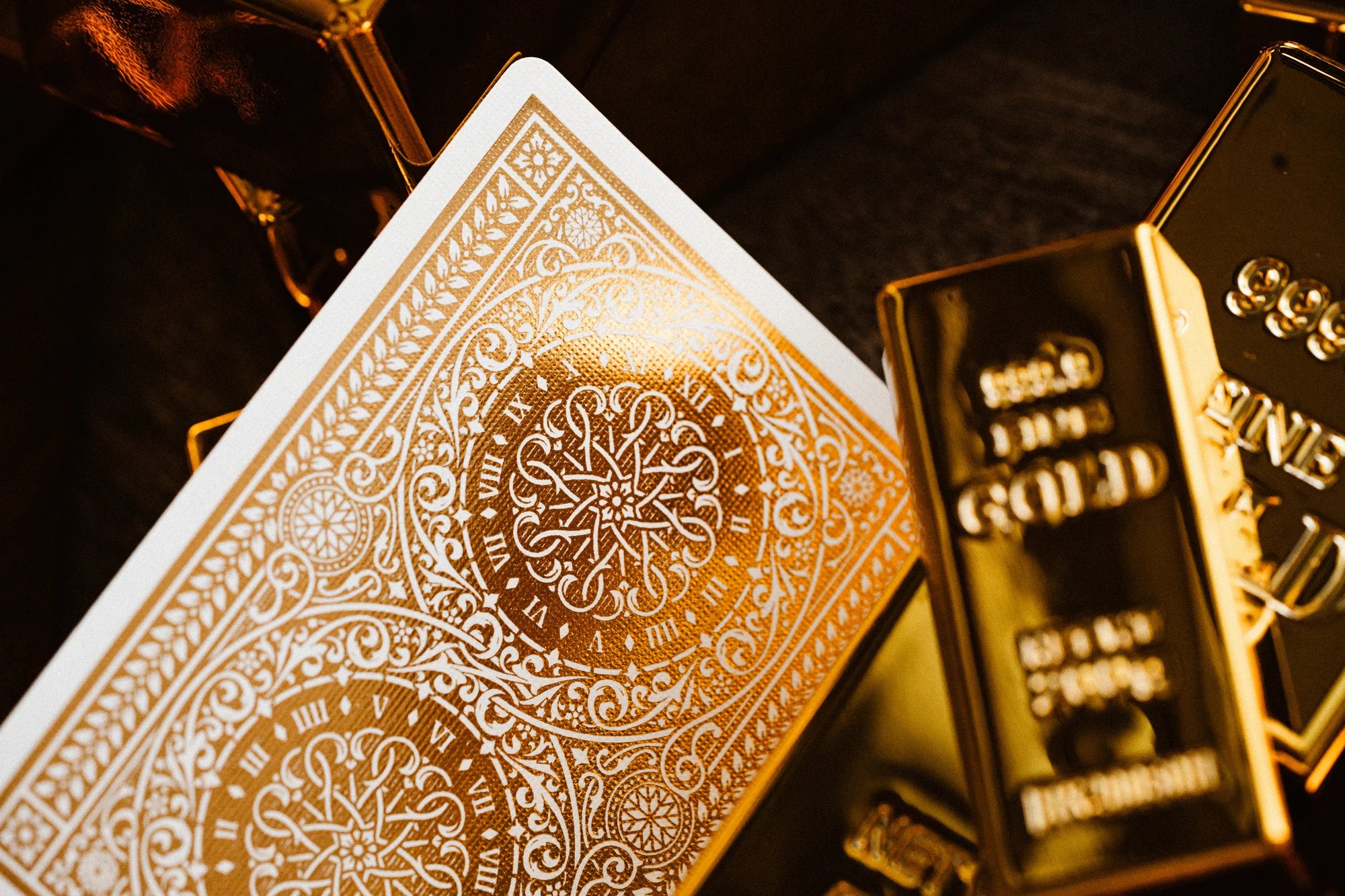 Tycoon 25th Anniversary playing card back surrounded by multiple 500g gold bars.