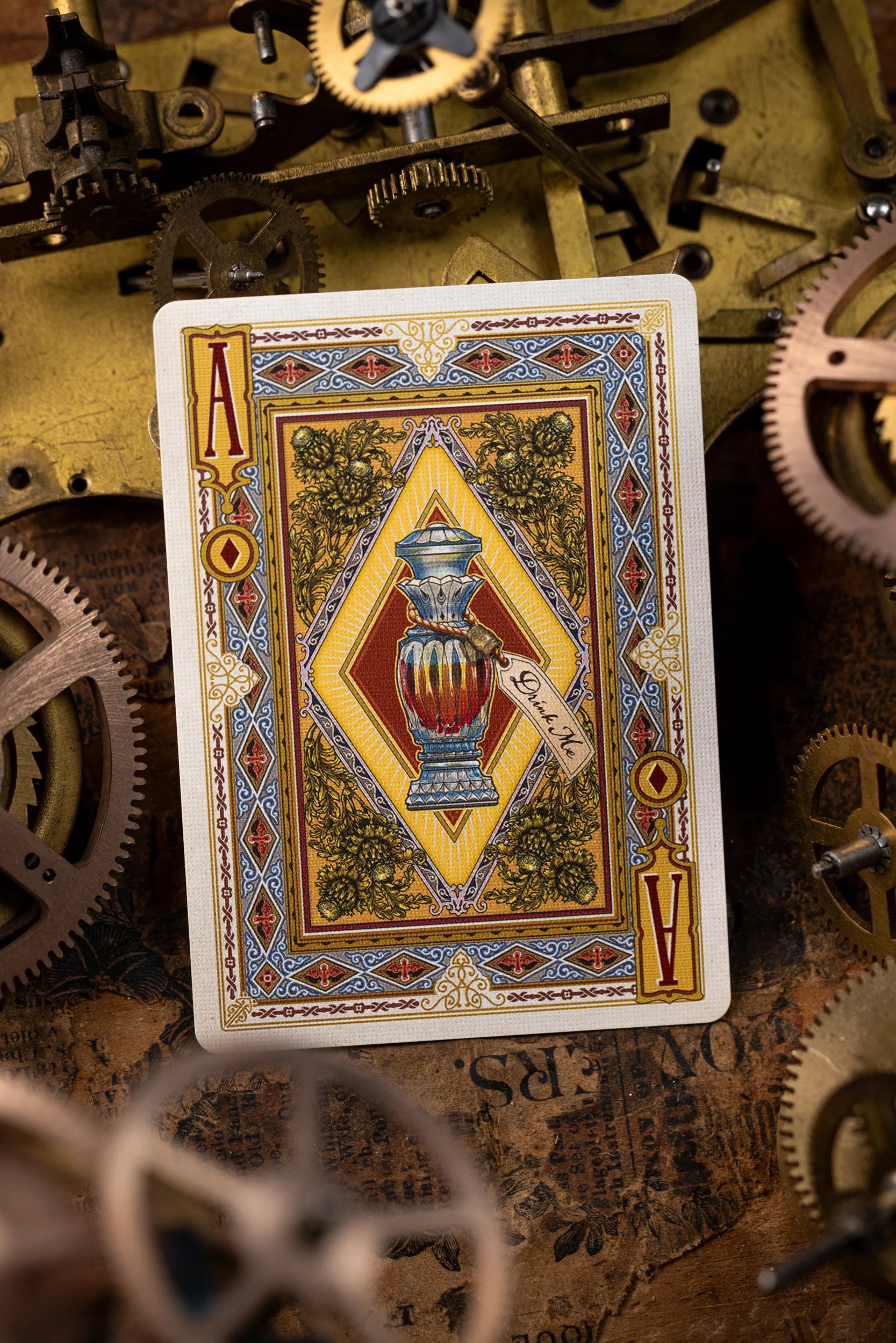 Playing card with a decorative design on a background of mechanical gears