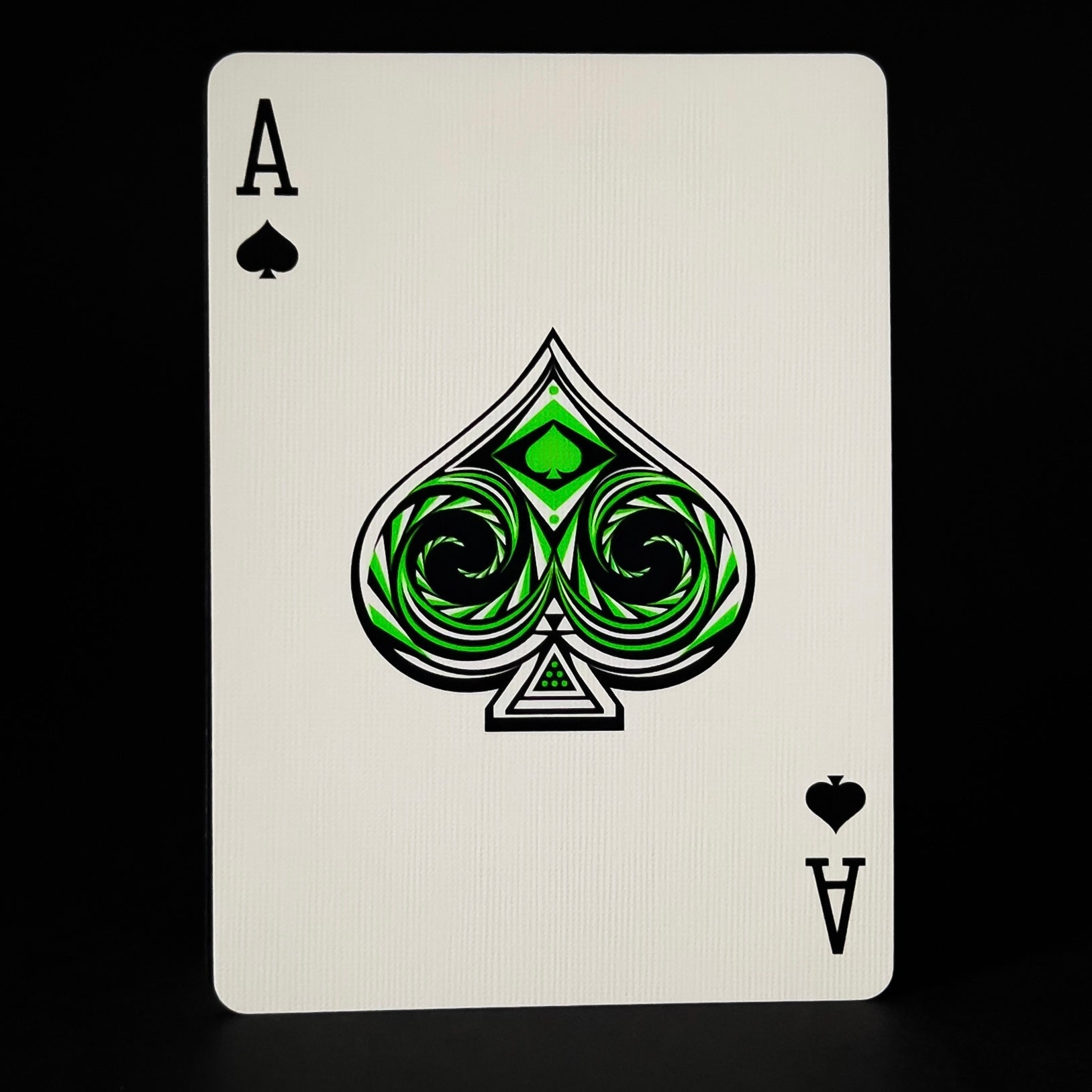Ace of Spades Descendents playing card with green spade symbol on a black background