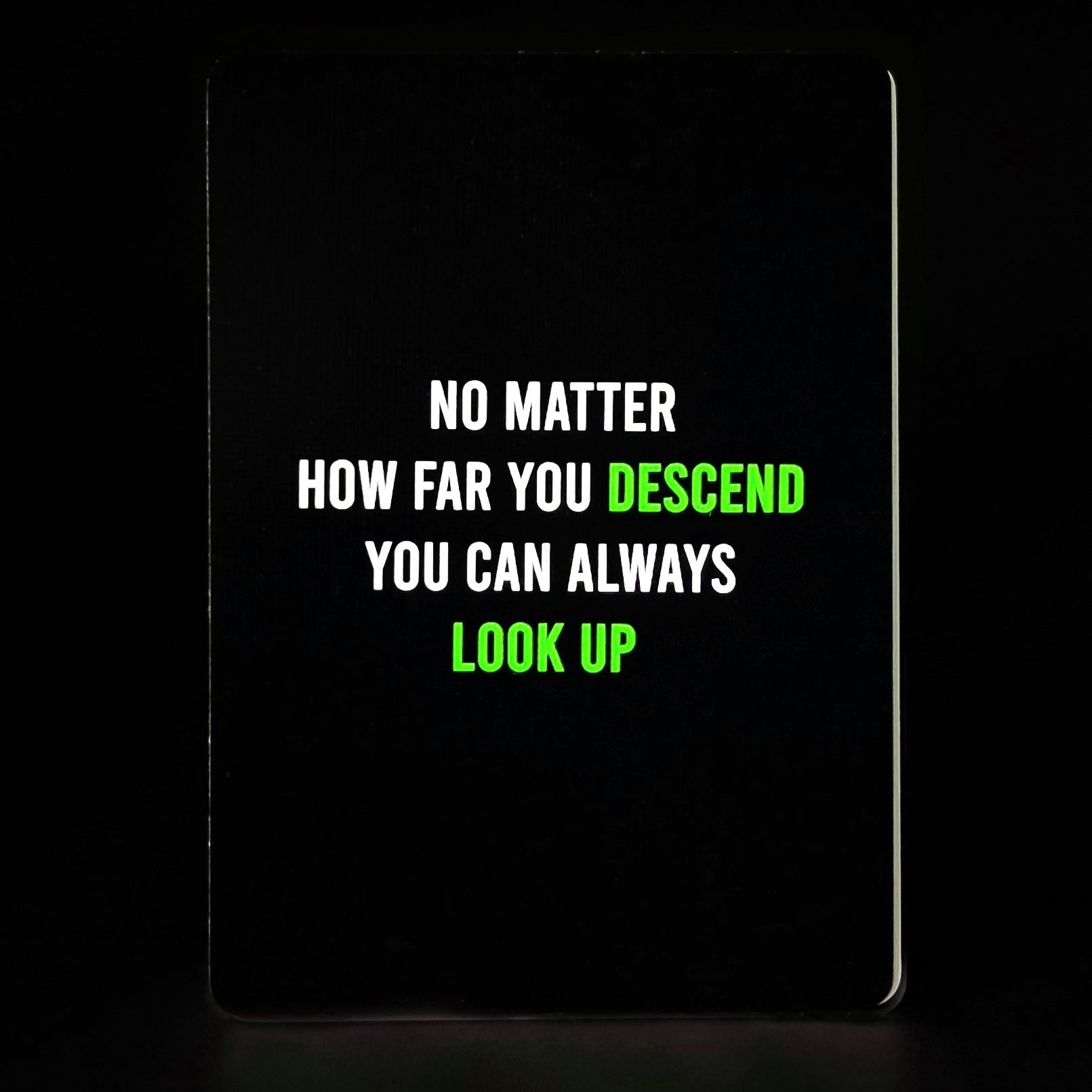Motivational quote on a black background with white and green text.