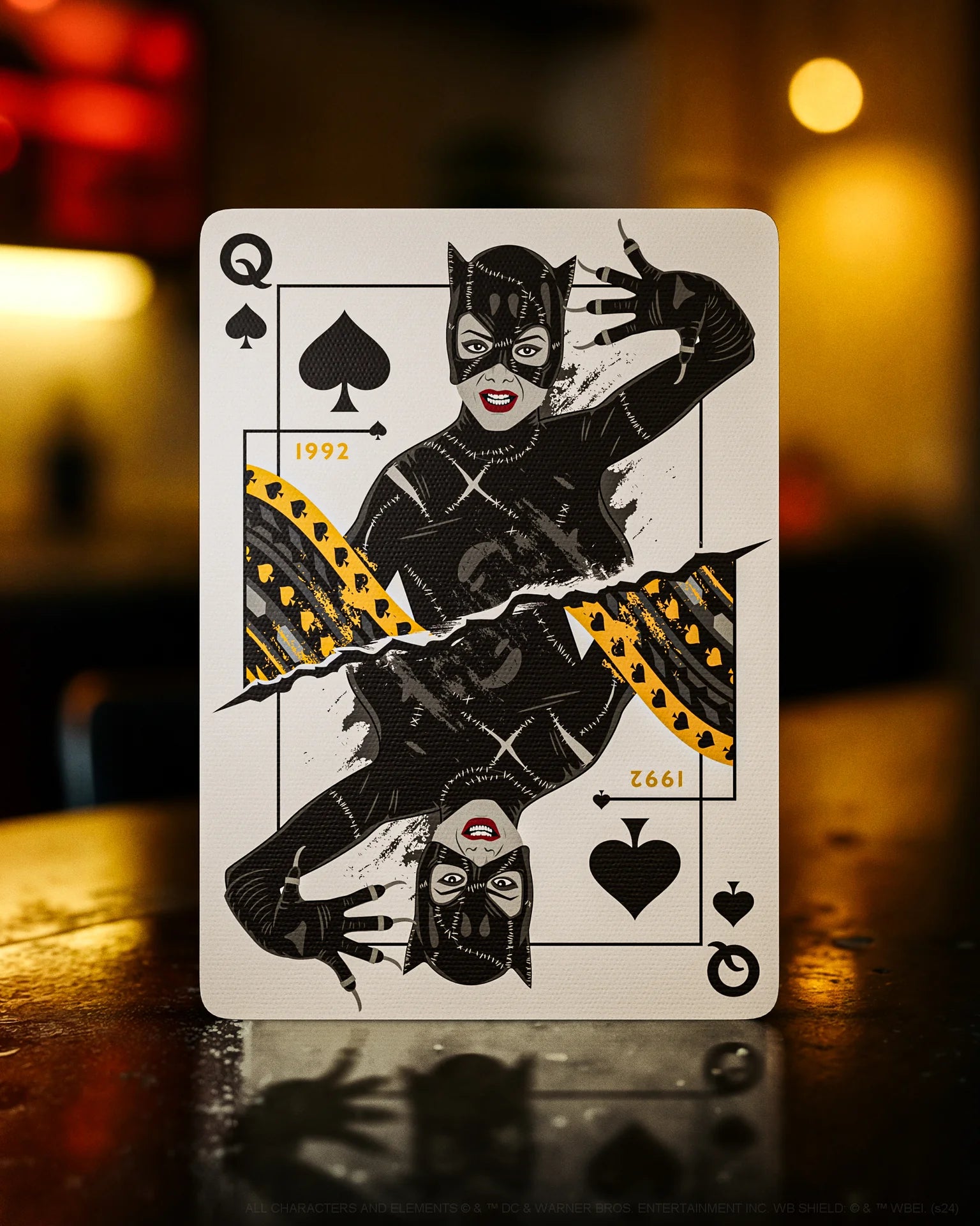 Playing card with a stylized illustration of a character in a black outfit on a blurred background