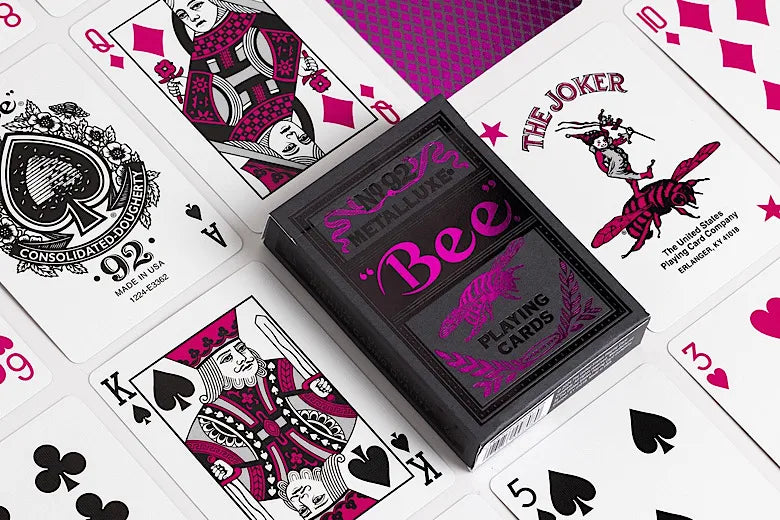 Bee Magenta & Black Metalluxe playing cards with visible branding and card suits on a white background