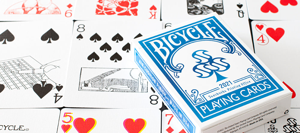 Bicycle Sanshusha Playing Cards Blue displayed with custom tuck box, black spade pips, and custom illustrated extra cards