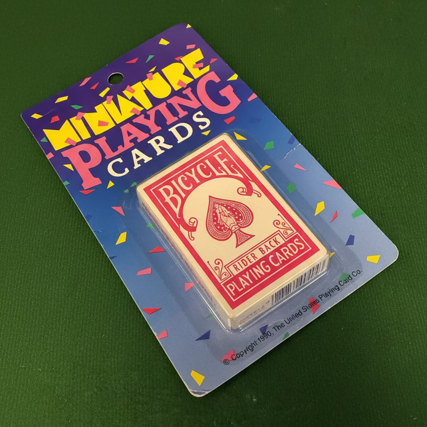 Bicycle miniature playing cards in original blister packaging, featuring the Rider Back design from 1990 on a blue card backing with colorful confetti graphics.