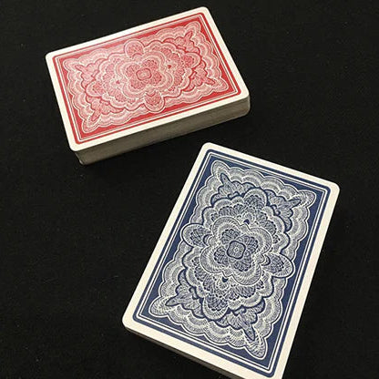 Two playing Blue Ribbon card boxes, one red and one blue, on a black background