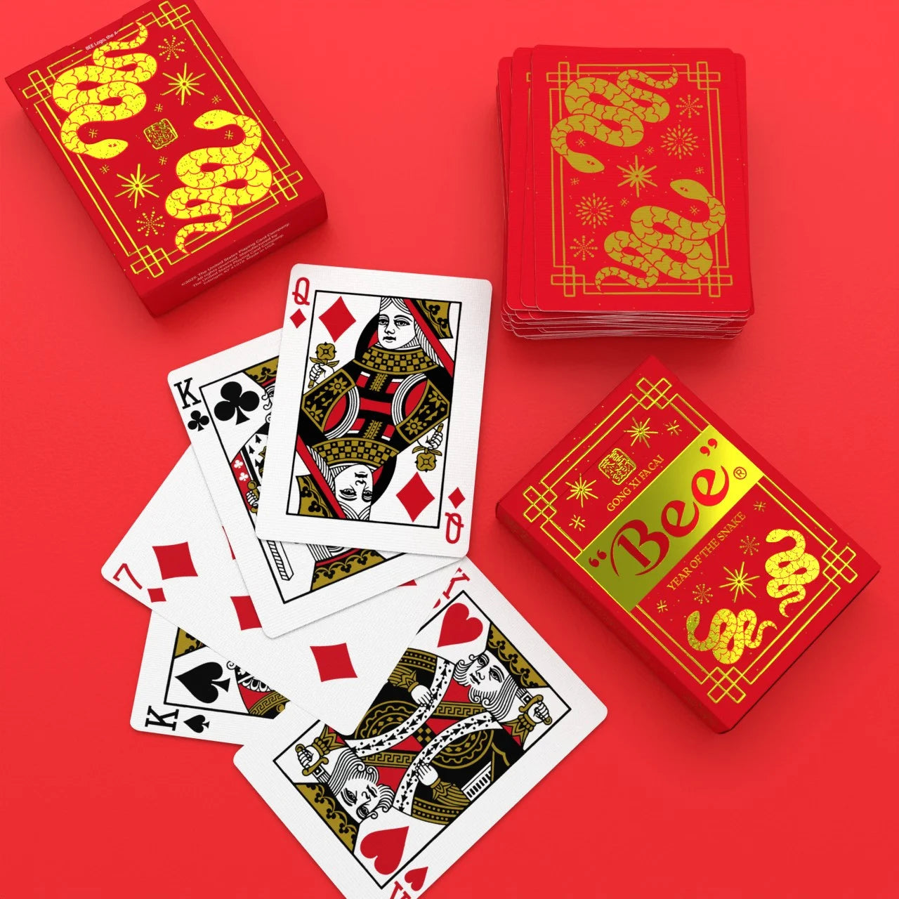 Bee Year of the Snake Playing Cards with red tuck box, custom snake backs, and standard courts on bright red background