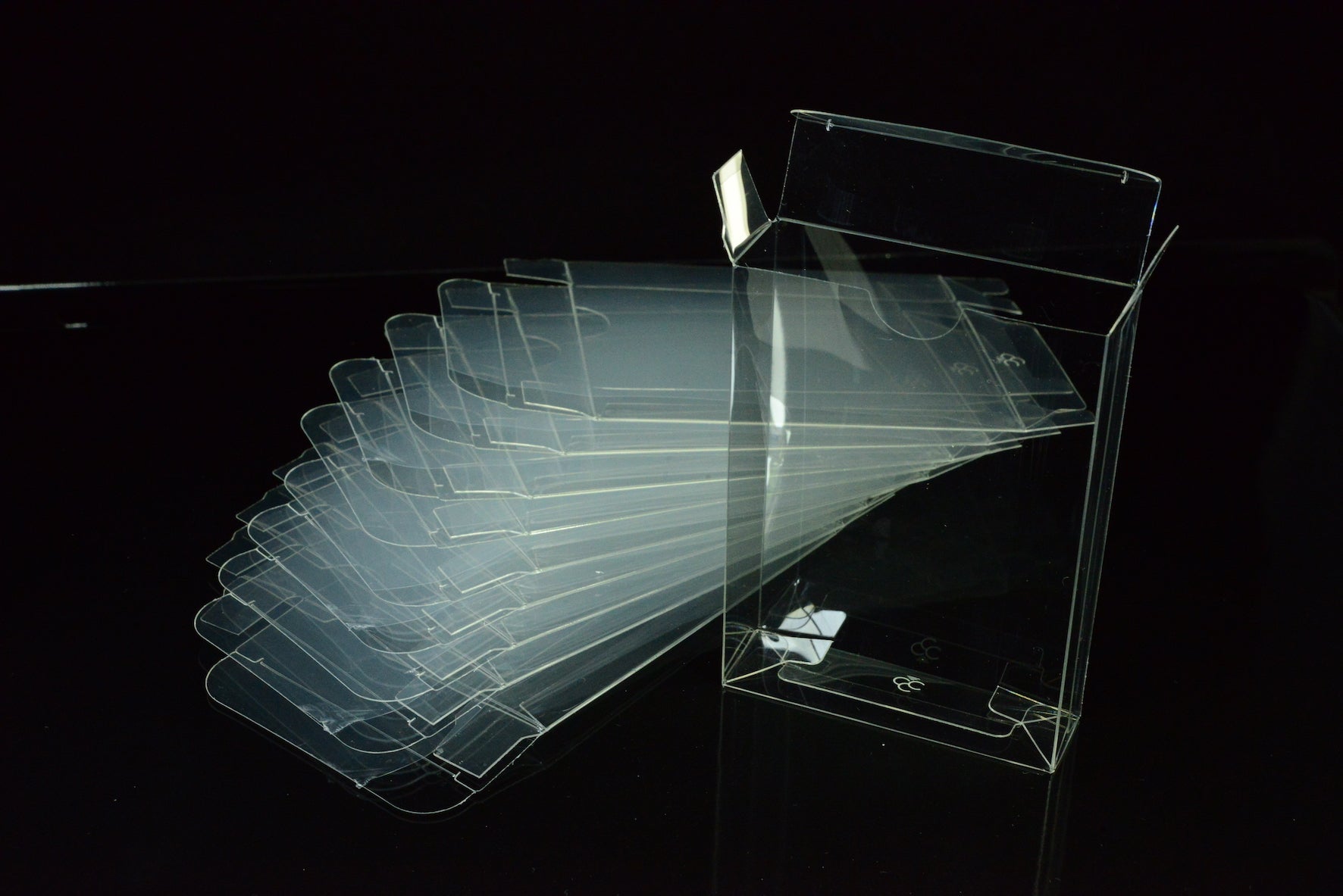 Clear acrylic display stands on a black background