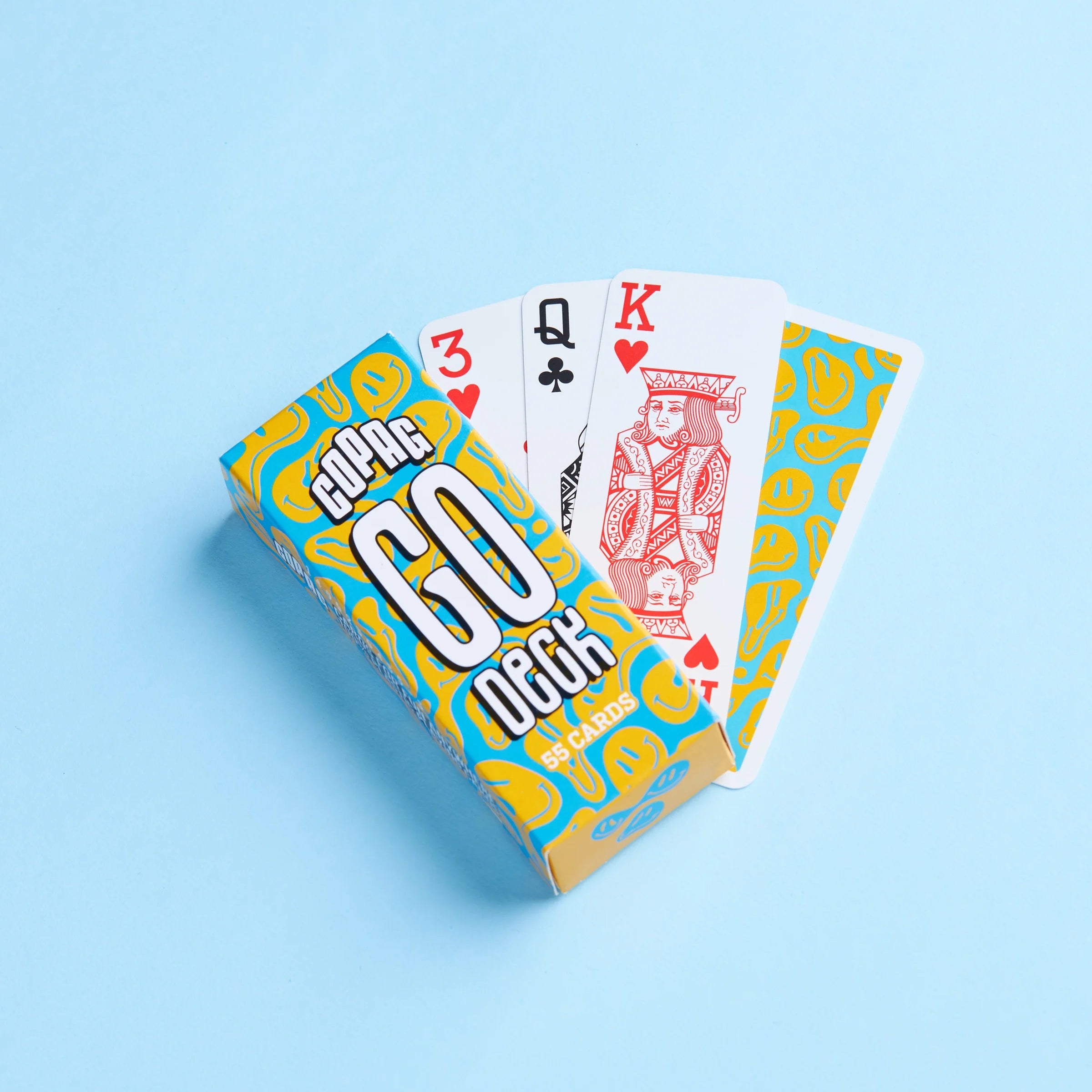 Copag Go Deck – Smiles Design Playing cards with a blue and yellow deck cover on a light blue background