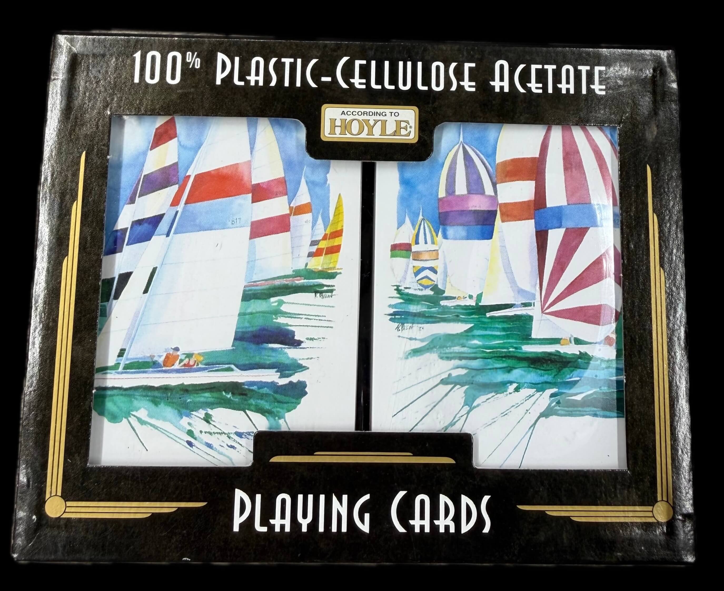 Set of Hoyle 100% Cellulose Acetate playing cards with sailboat design on a black background with According to Hoyle branding