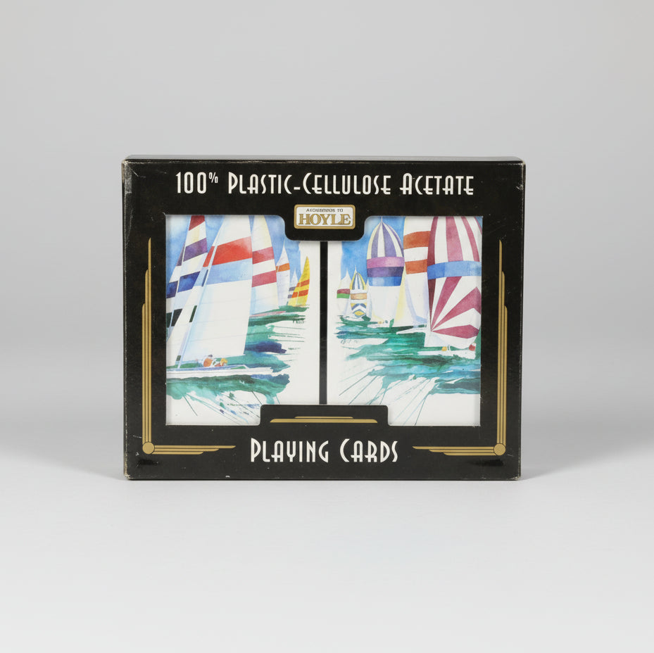 Set of Hoyle 100% Cellulose Acetate playing cards with sailboat design on a black background with According to Hoyle branding