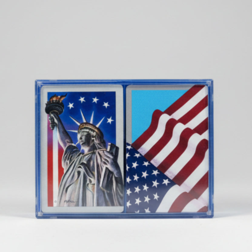 Two Hoyle playing card designs featuring the Statue of Liberty and an American flag